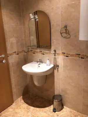 a bathroom with a sink and a mirror at Nickmar Studio-Apartment in Bansko