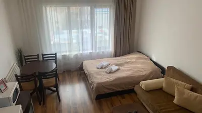 a small room with a bed and a table and chair at Nickmar Studio-Apartment in Bansko