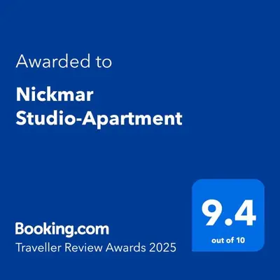 a blue sign with the text awarded to nitzker student studio apartment at Nickmar Studio-Apartment in Bansko