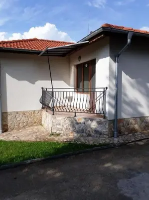 a small white house with a balcony on it at Вили Green in Tsigov Chark
