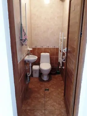a small bathroom with a toilet and a sink at Вили Green in Tsigov Chark