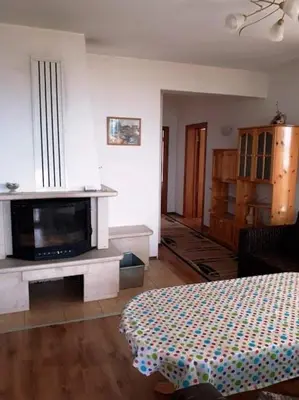 a living room with a fireplace and a tv in it at Вили Green in Tsigov Chark