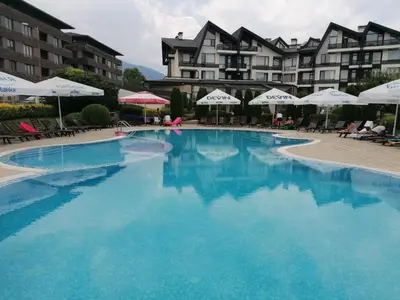 a large swimming pool in front of a hotel at Aspen Golf - private apartments in Razlog