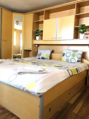 a large bed in a room with a large bedvisor at Pavlovi Apartments in Samokov
