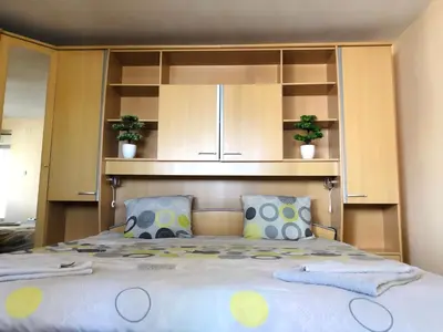 a bedroom with a large bed with wooden cabinets at Pavlovi Apartments in Samokov