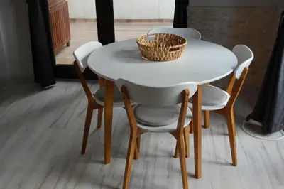 a white table with chairs and a basket on top at Bendida Apartments in Velingrad