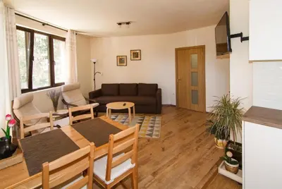 a living room with a table and a couch at Bendida Apartments in Velingrad