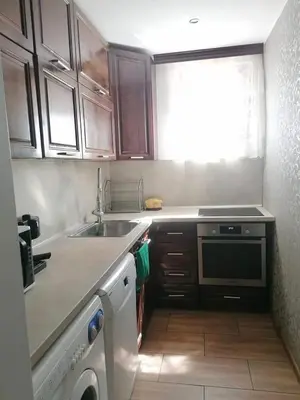 a small kitchen with a sink and a microwave at Къща за гости ЕКО in Tsigov Chark