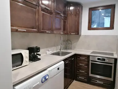 a kitchen with a sink and a microwave at Къща за гости ЕКО in Tsigov Chark
