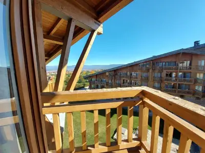a balcony with a view of a building at Airy Studio Pirin Golf Aparthotel SPA H2A92 in Razlog