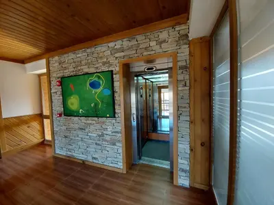 a hallway of a house with a stone wall at Airy Studio Pirin Golf Aparthotel SPA H2A92 in Razlog