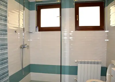 a bathroom with a shower and a toilet at Къщи за гости 