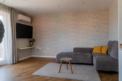 a living room with a couch and a brick wall at 