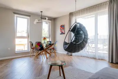a living room with a table and a swing at 
