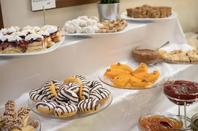 a buffet with several plates of desserts on a table at Borovets Green Hotel in Borovets