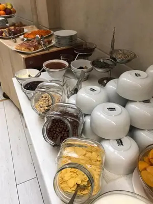 a counter with many different types of food on it at Borovets Green Hotel in Borovets