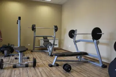 a gym with several exercise equipment in a room at Borovets Green Hotel in Borovets