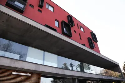 a red building with black windows on top of it at Boutique Hotel Kanyon in Sofia