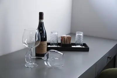 a bottle of wine and two glasses on a counter at Boutique Hotel Kanyon in Sofia