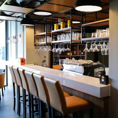 a bar in a restaurant with a row of chairs at Boutique Hotel Kanyon in Sofia