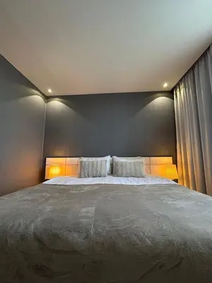 a bedroom with a large bed with two pillows at Boutique Hotel Kanyon in Sofia
