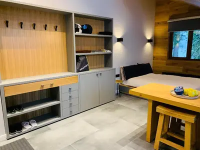 a bedroom with a bed and a table and a tableablish at Golden Box Pamporovo in Pamporovo