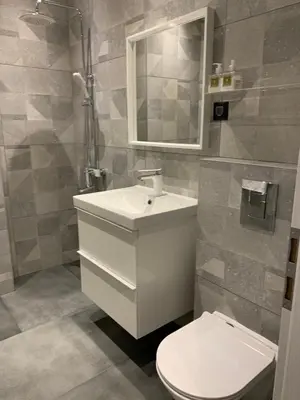 a bathroom with a toilet and a sink and a mirror at Golden Box Pamporovo in Pamporovo