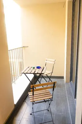 a table and two chairs sitting on a balcony at Fancy Big apartment in the heart of Sofia in Sofia