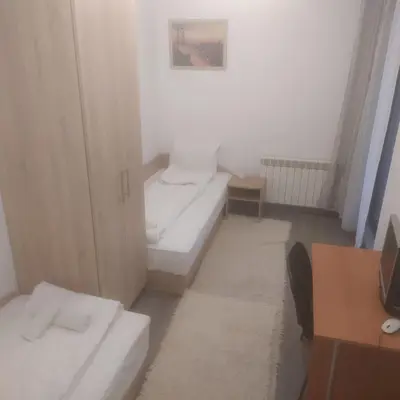 a small room with two beds and a television at Fancy Big apartment in the heart of Sofia in Sofia