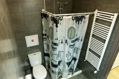 a bathroom with a toilet and a shower curtain at Fancy Big apartment in the heart of Sofia in Sofia