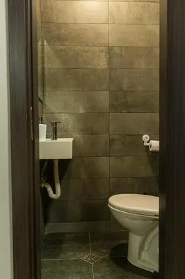 a bathroom with a toilet and a sink at Fancy Big apartment in the heart of Sofia in Sofia