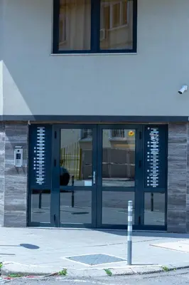 an entrance to a building with glass doors at Fancy Big apartment in the heart of Sofia in Sofia