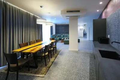 a dining room with a long wooden table and chairs at GRAFFIT Luxury houses in Ognyanovo