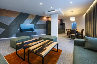 a living room with a couch and a table at GRAFFIT Luxury houses in Ognyanovo