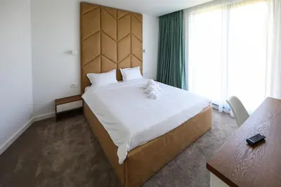 a bedroom with a large bed with a wooden headboard at GRAFFIT Luxury houses in Ognyanovo