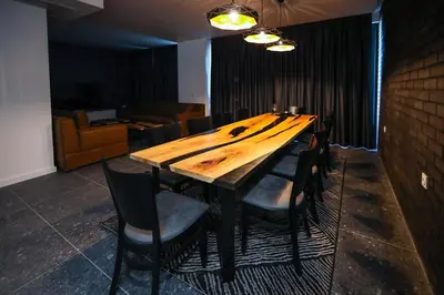 a wooden table in a room with chairs around it at GRAFFIT Luxury houses in Ognyanovo