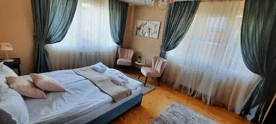a bedroom with a bed with blue drapes at Infinity Boutique Apartments in Bansko