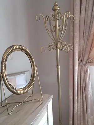 a gold mirror and a mirror stand next to a mirror at Infinity Boutique Apartments in Bansko