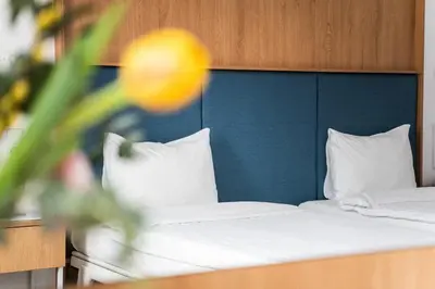two beds in a hotel room with white sheets and pillows at Hotel Kitchen59 in Sofia