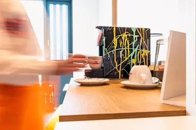a table with plates and a cup on top of it at Hotel Kitchen59 in Sofia