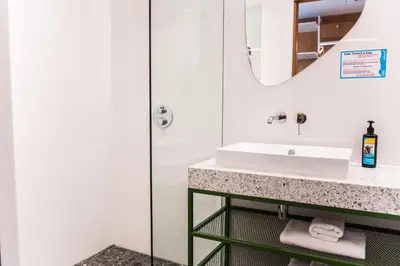 a bathroom with a sink and a mirror at Hotel Kitchen59 in Sofia