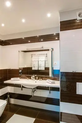 a bathroom with two sinks and a mirror at Hotel Villa Ekaterina in Vakarel