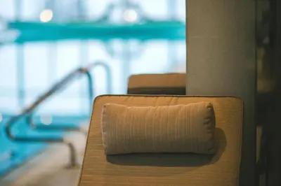 a rolled up napkin sitting on top of a chair at Hotel Villa Ekaterina in Vakarel
