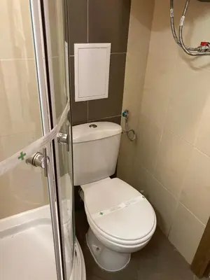 a small bathroom with a toilet and a shower at Mirabell Studio Bansko - Amazing view & fireplace in Bansko