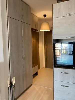 a living room with a tv and a entertainment center at Mirabell Studio Bansko - Amazing view & fireplace in Bansko