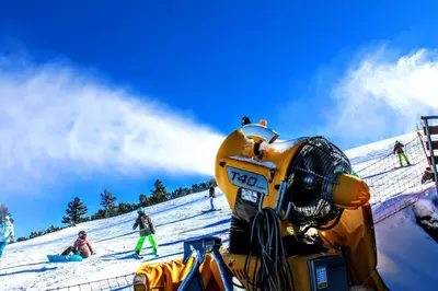a bulldozer on top of a snow covered slope at Villa Anna Luxury Lake Residence in Shtarkelovo Gnezdo