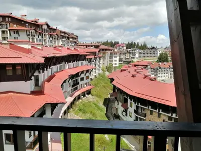 arial view of buildings with red roofs in a city at GRAND MONASTERYl Apartment ``Star Paradise`` in Pamporovo