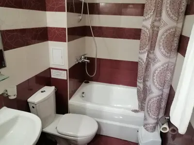 a bathroom with a toilet and a tub and a sink at GRAND MONASTERYl Apartment ``Star Paradise`` in Pamporovo