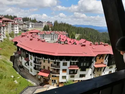 arial view of a building with a red roof at GRAND MONASTERYl Apartment ``Star Paradise`` in Pamporovo