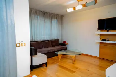 a living room with a couch and a table at Luxury houses in Dobrinishte in Dobrinishte